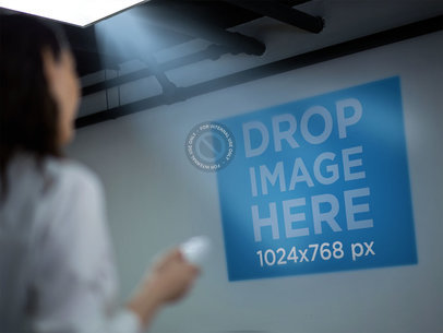 Woman Holding a Remote While Watching an Office Presentation Mockup a16310